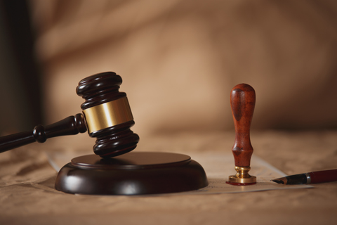 A wooden gavel resting on a legal document, symbolizing the probate court process in estate planning and elder law.