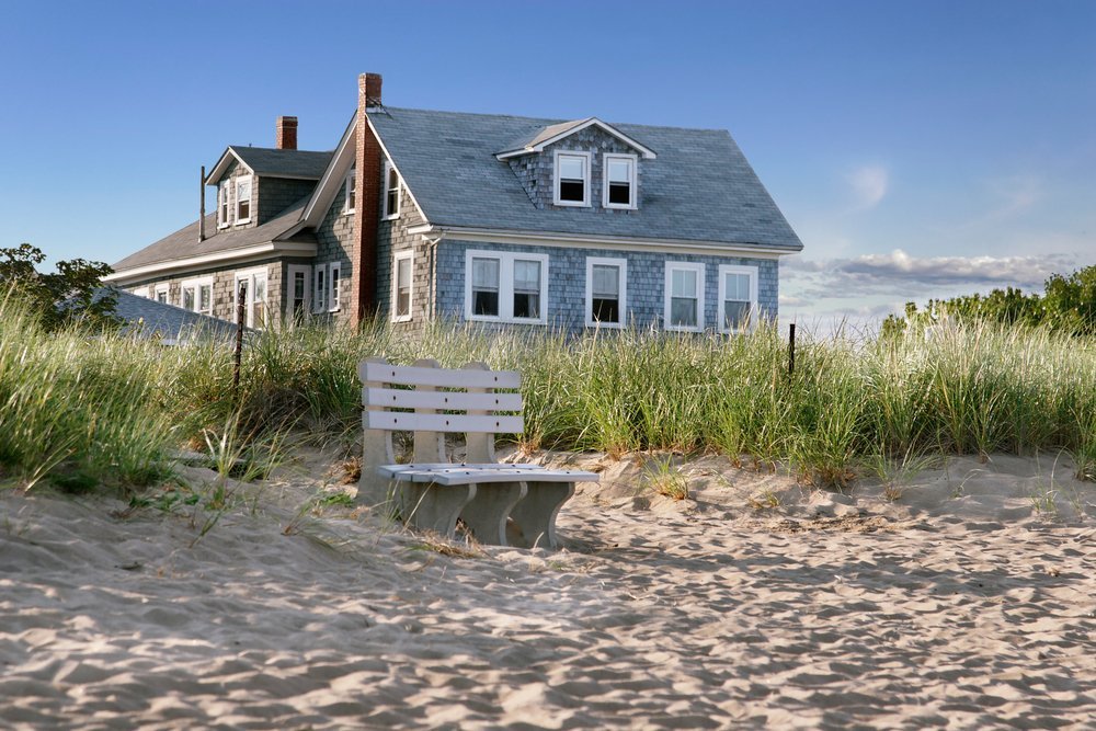 Scenic view of a vacation home nestled in a peaceful setting, symbolizing estate planning challenges for transferring vacation properties to the next generation in elder law discussions.