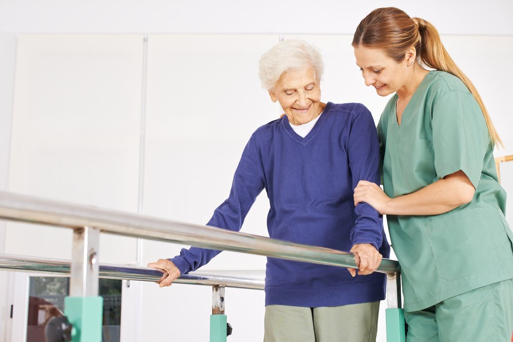 A healthcare professional assisting an elderly patient in a rehabilitation setting, highlighting the differences in care between inpatient rehabilitation facilities and skilled nursing facilities, relevant to estate planning and elder law considerations.
