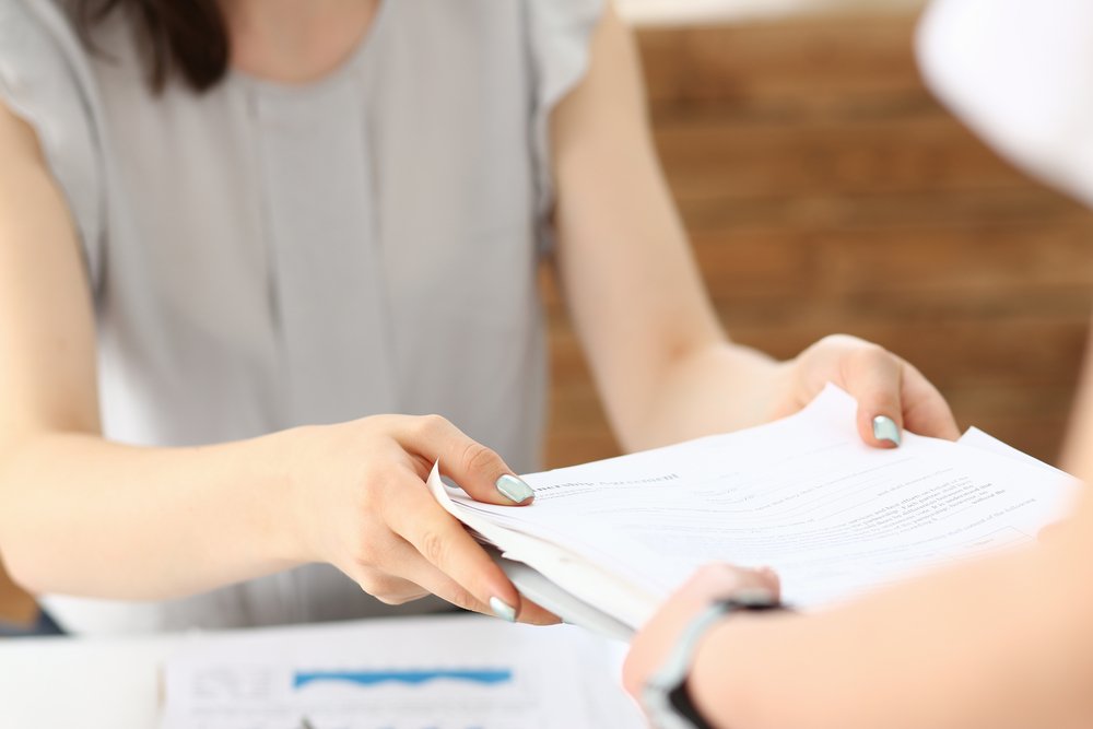 A person is organizing estate planning documents, highlighting the responsibilities and duties of an executor in managing a deceased individual's estate.