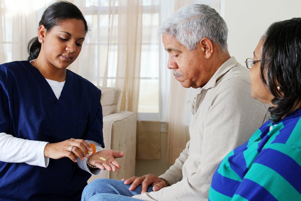 A Hispanic caregiver assists an elderly woman, illustrating the potential impact of immigration policies on the availability of caregivers for aging populations.