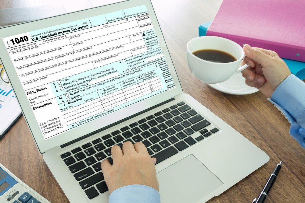 A senior couple using a laptop at home, reflecting on tax preparation and financial planning options available for older adults.
