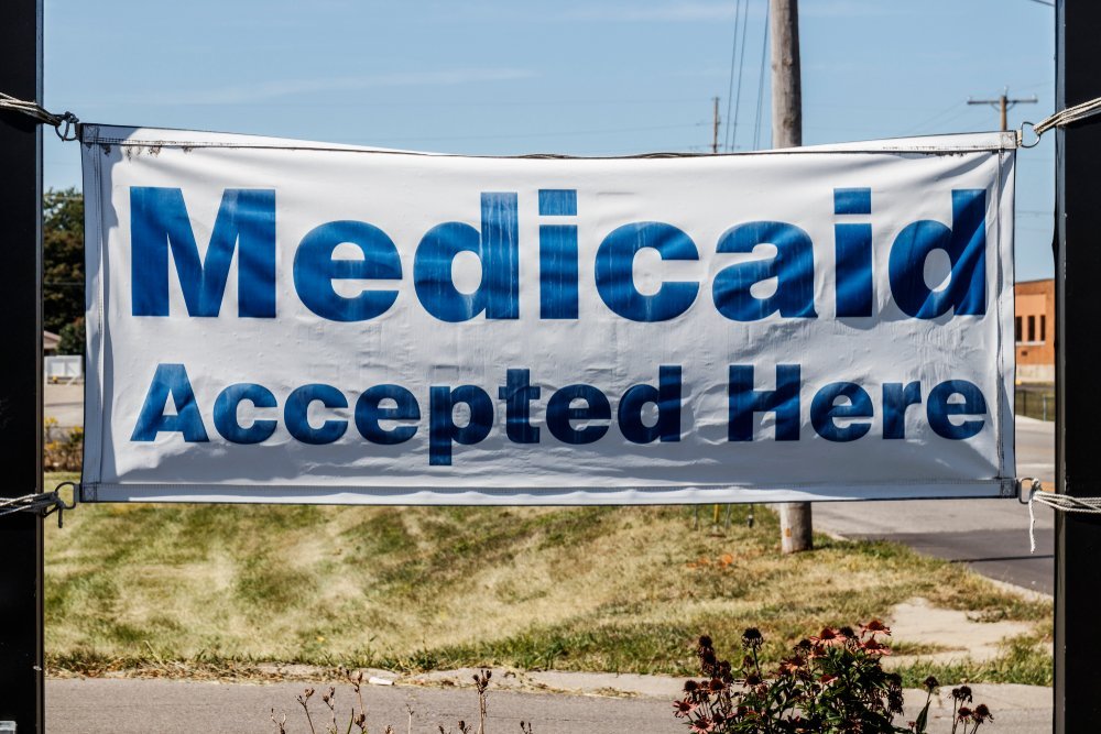 Image of a gavel and a medical stethoscope on a desk, representing the intersection of law and healthcare during the pandemic, significant for understanding Medicaid benefits protection under COVID-19 regulations.