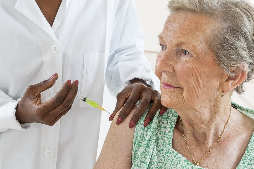 Image of a healthcare professional holding a vaccine vial, symbolizing Medicare's coverage of COVID-19 vaccines relevant to estate planning and elder law.