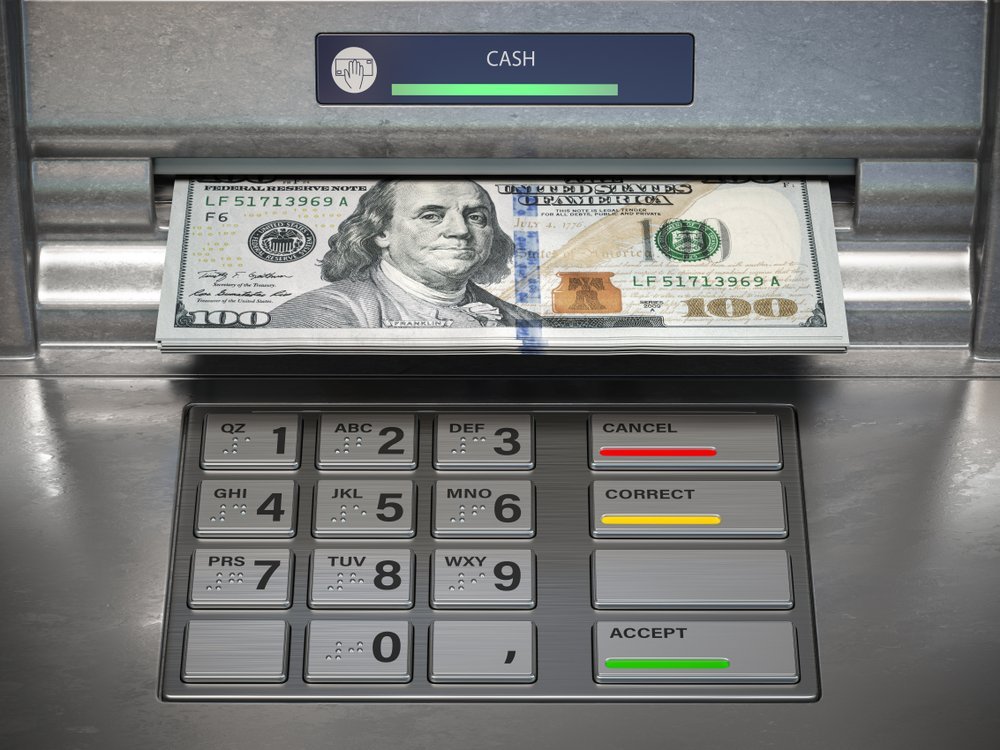 Image depicting a person withdrawing cash from an ATM, illustrating the option of early retirement fund withdrawals under the CARES Act.