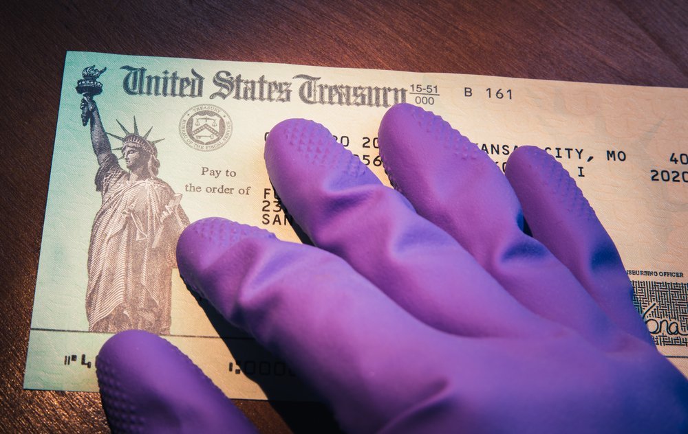 A close-up of a COVID-19 relief check issued by the U.S. Treasury, representing the financial aid provided to individuals, including those in nursing homes, during the pandemic.