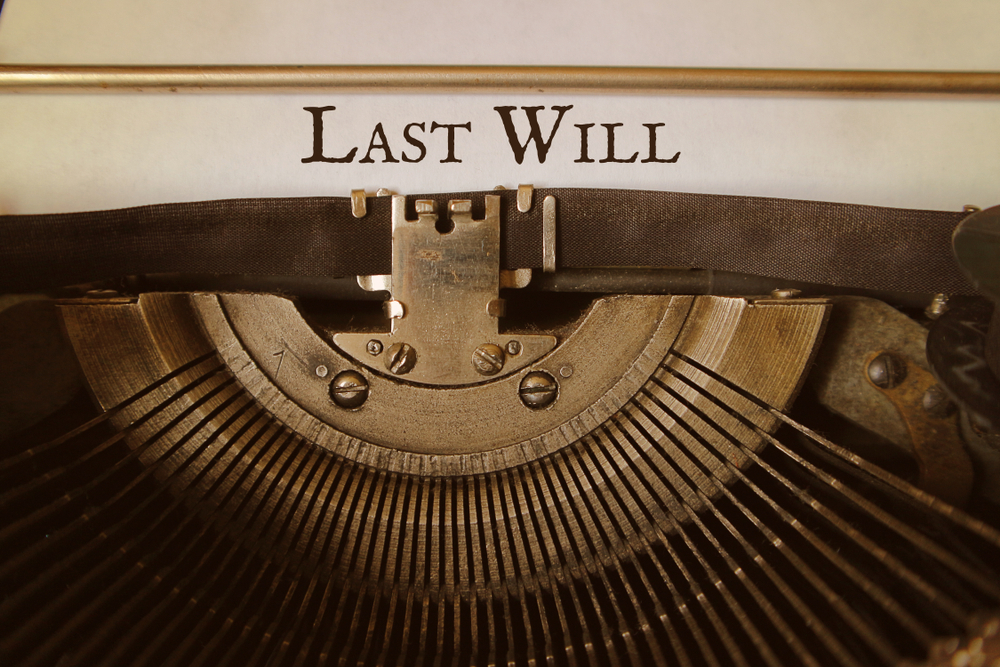 Close-up of a last will and testament document alongside a pen and reading glasses, highlighting the importance of legal guidance in estate planning and elder law.