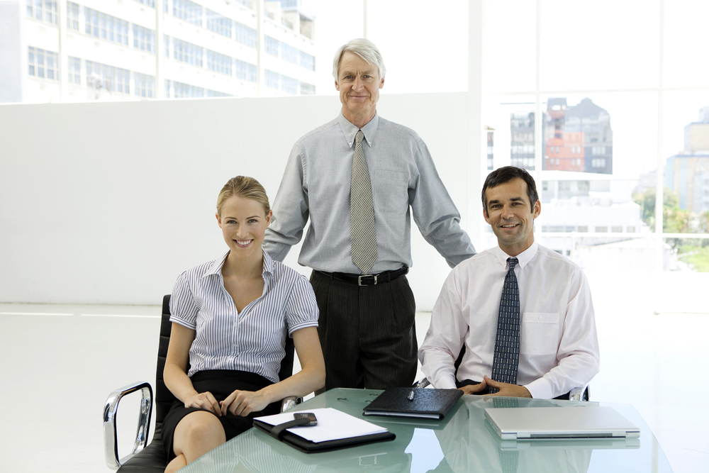 A multigenerational family discussing estate planning for their family business, focusing on reducing estate taxes through minority valuation discounts.