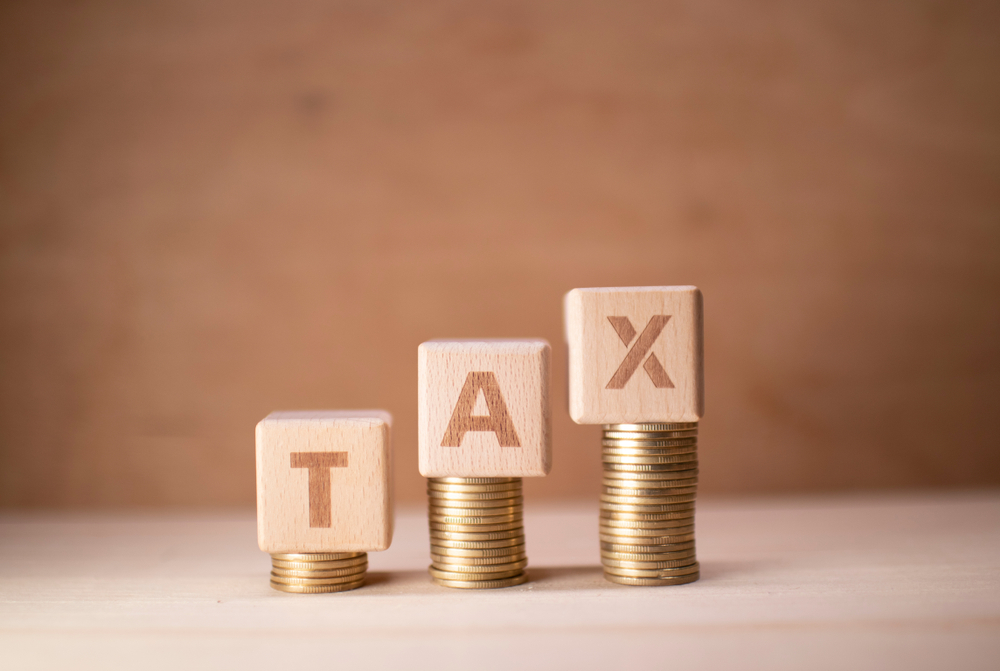 Image depicting tax documents and calculator, emphasizing the need to review estate plans in light of new tax proposals affecting estate and elder law.