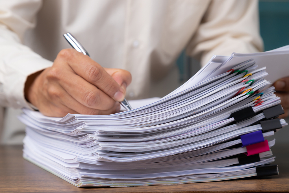 A stack of legal documents representing the responsibilities and tasks involved in being an executor of an estate, emphasizing the complexities and time commitments of administering an estate.