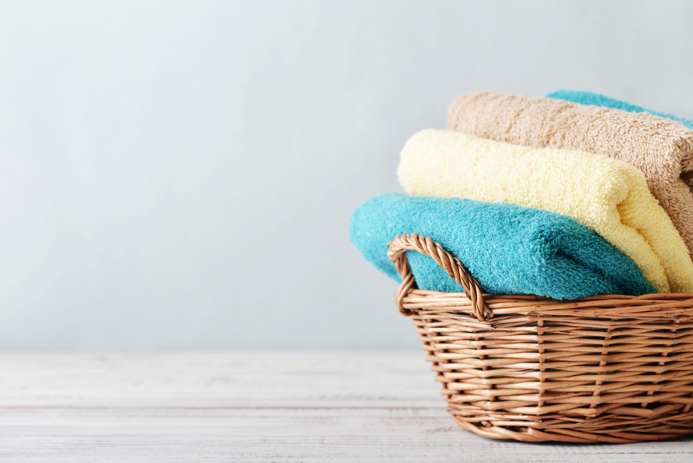 Wicker basket containing colorful towels on a light background, symbolizing considerations for home support services in the context of Medicare for seniors.