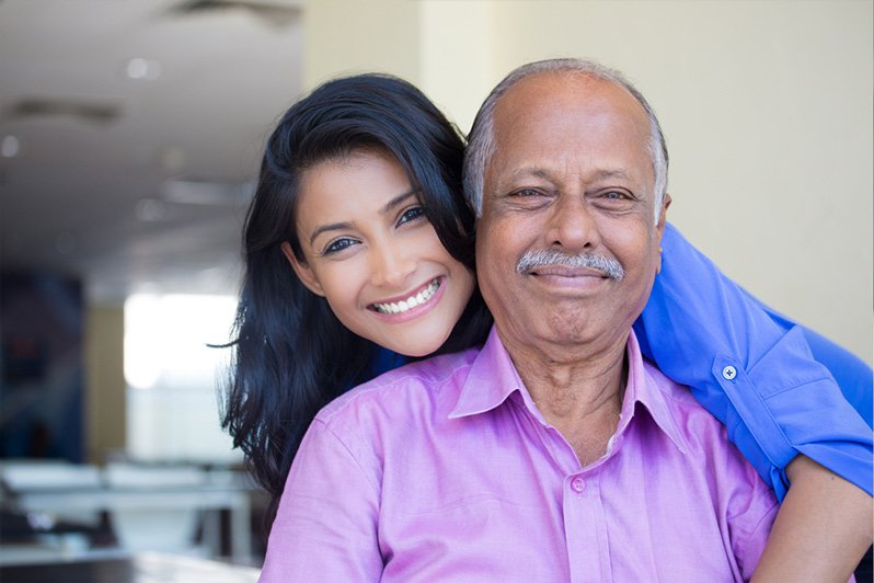 A middle-aged man and his adult daughter thoughtfully discussing estate planning matters, emphasizing the importance of selecting a personal representative for managing the estate's administration.