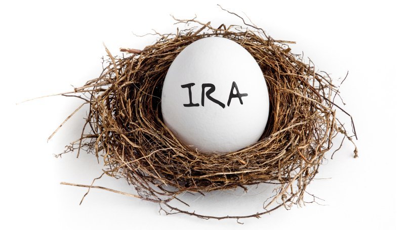 A person reviewing documents related to Roth 401(k) plans, highlighting tax implications and contributions for estate planning and elder law.