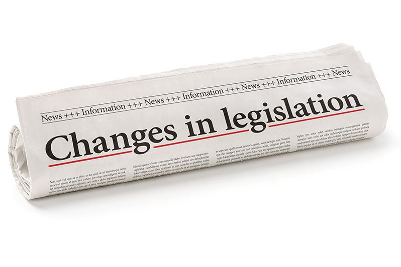 Legislative documents on a wooden desk symbolizing the introduction of new bills regarding the repeal of estate and GSTT taxes, crucial for estate planning and elder law.