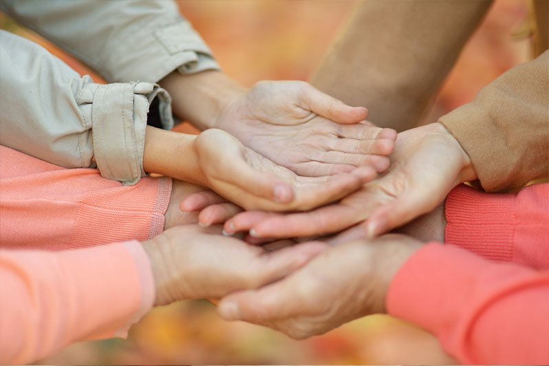A family discussing estate planning with a legal advisor, focusing on differences between living trusts and irrevocable trusts, to understand their respective benefits for asset protection and tax savings.