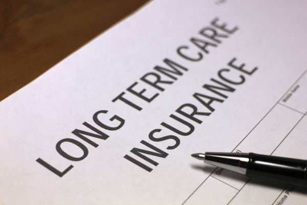 Image showing documents related to long-term care insurance and tax deduction calculations, highlighting the importance of understanding premium deductions for estate planning and elder law.