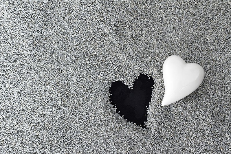 Image of a grieving person surrounded by legal documents, illustrating the burdens of estate management after a loved one's death.