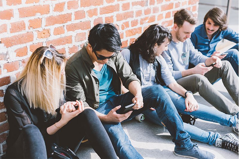 A group of Millennials engaged in a discussion about wealth management and estate planning strategies, highlighting their approach to financial planning and security.