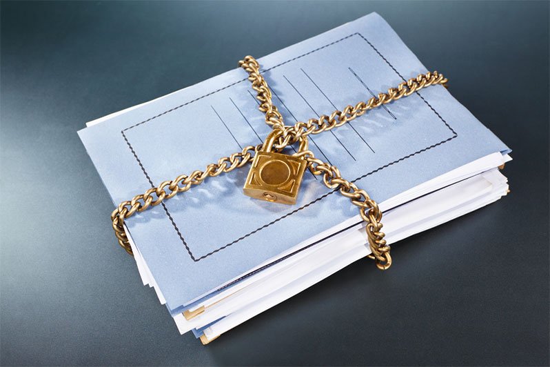 Image of lock and papers symbolizing secure storage of estate planning documents to emphasize privacy in estate planning and elder law.