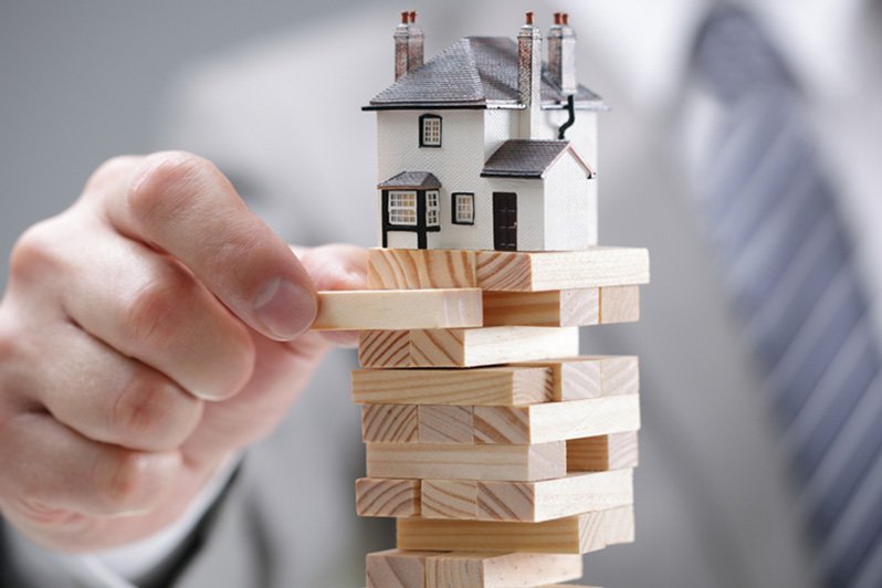 A concerned investor reviews real estate documents, indicating the importance of understanding potential risks and liabilities associated with real estate investments in estate planning and elder law contexts.