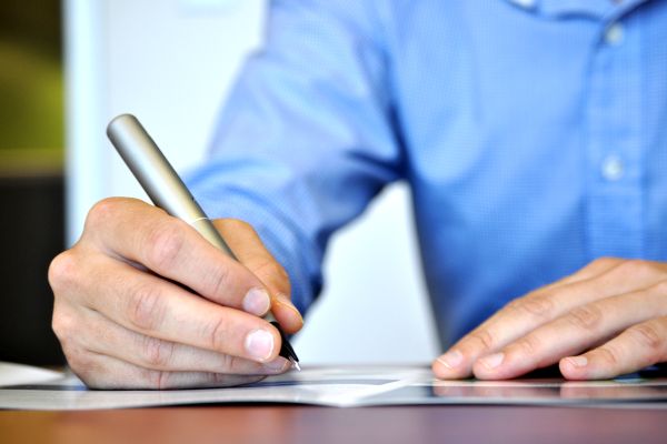 A senior couple reviewing estate planning documents at a table, symbolizing the importance of updating and revisiting estate plans as part of New Year's resolutions.