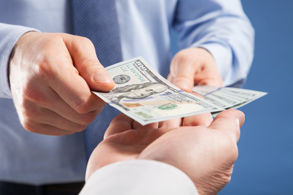 A couple reviewing estate planning documents, focusing on how wills can dictate debt payment, ensuring financial peace of mind for their heirs.