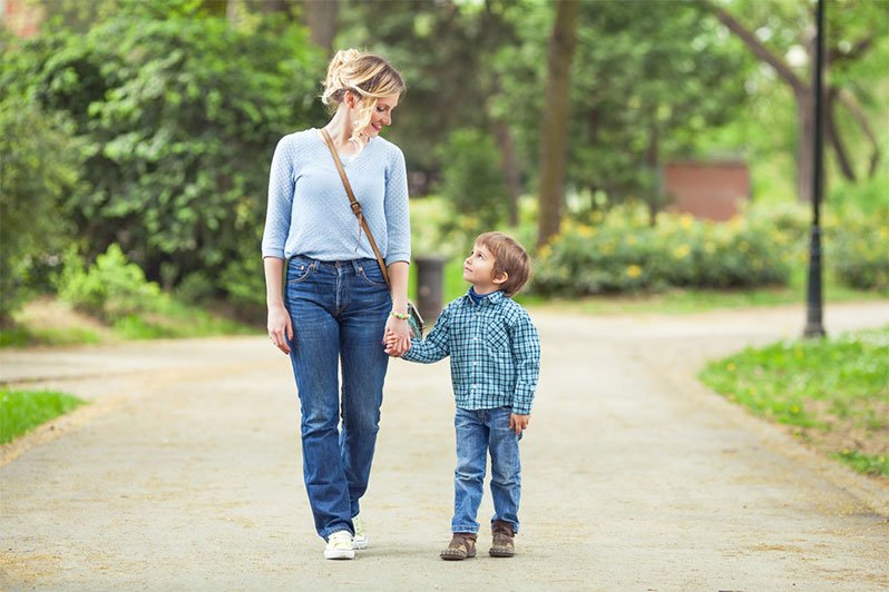 Single mother embracing her young son, emphasizing the importance of estate planning and guardianship for single parents to provide for their child's future.