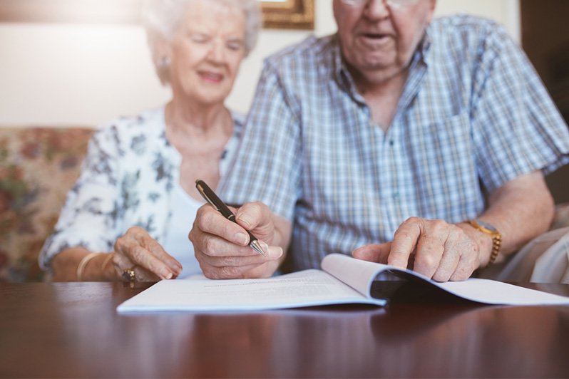 Close-up image of a person signing a will document, highlighting the critical role of estate planning in New Jersey, emphasizing the importance of having a comprehensive plan beyond just a will to avoid complications in intestate succession.