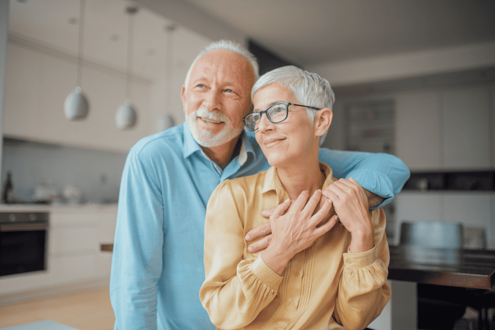 Older married couple smiling together in their kitchen, representing second marriage estate planning and blended family planning