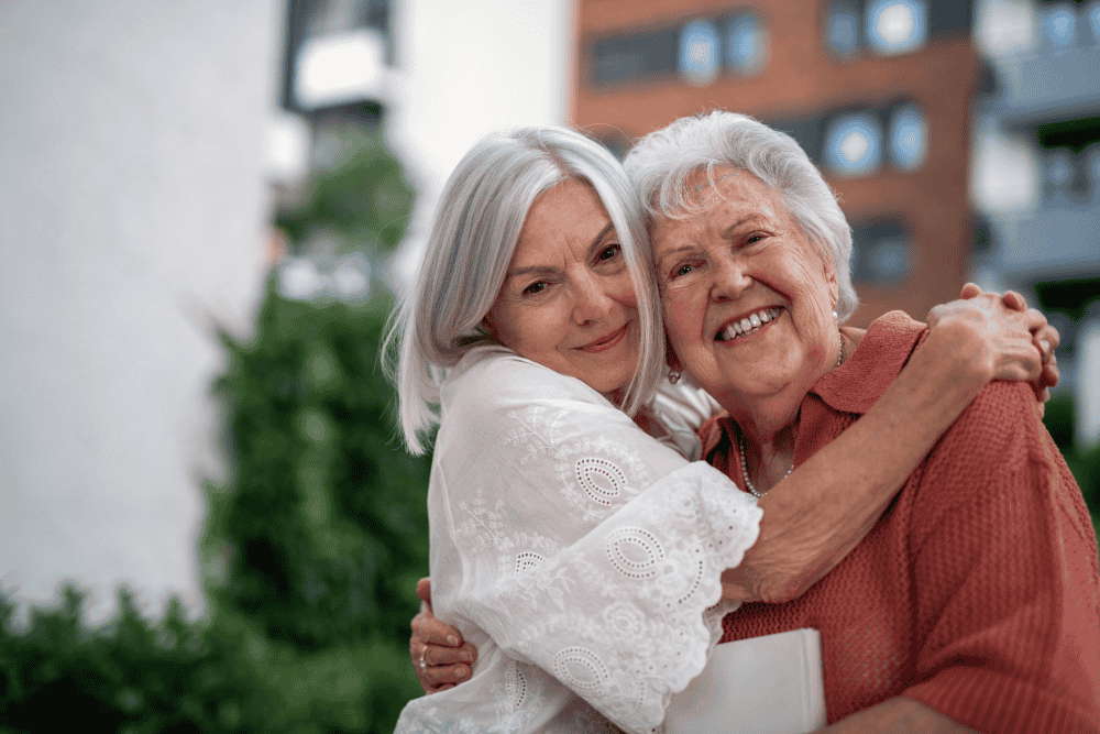 Adult daughter hugging her elderly mother, representing estate planning guidance that helps families avoid difficult decisions and conflict later.