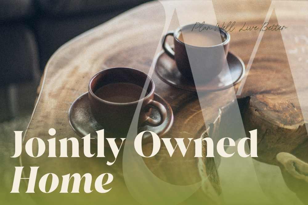 Two coffee cups on a wooden table with the words "Jointly Owned Home" — what happens to a jointly owned home when one spouse dies in New Jersey