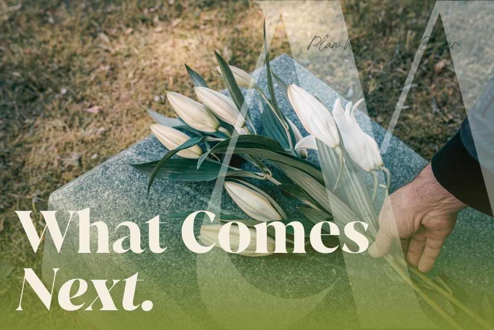 A hand placing white lilies on a gravestone, representing the financial and legal steps a surviving spouse must navigate in the weeks following the death of a partner.