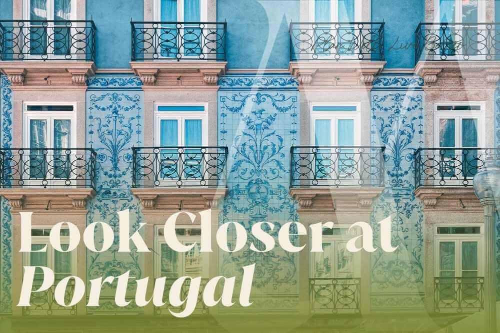 Blue tiled building facade with black wrought iron balconies in Portugal, with the headline "Look Closer at Portugal"